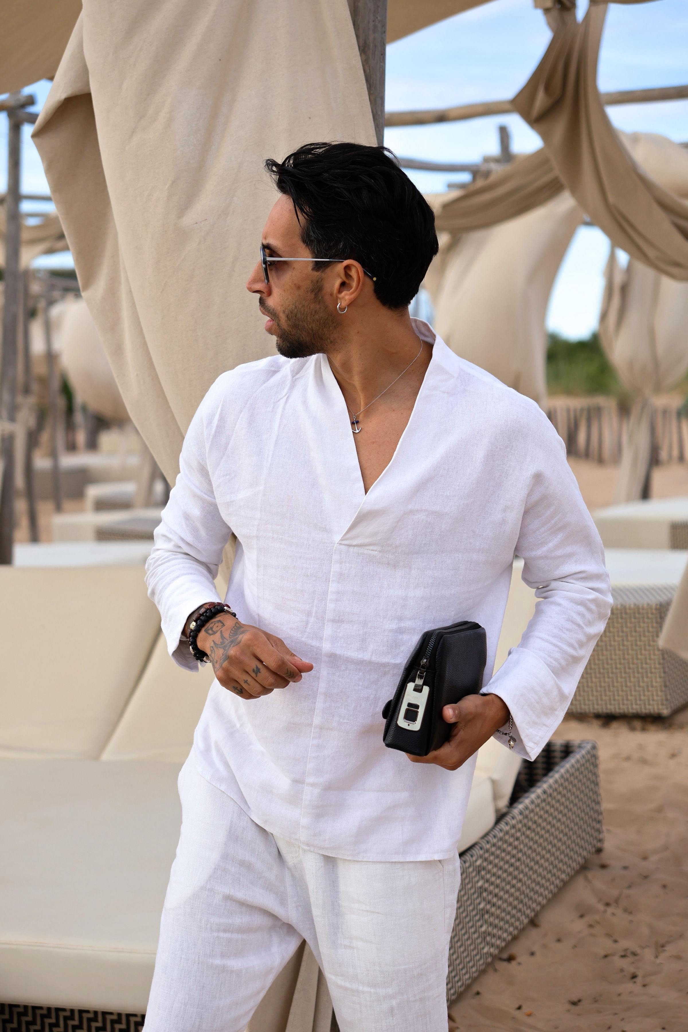 Model in white linen holding a Ferrucci pochette with fingerprint lock