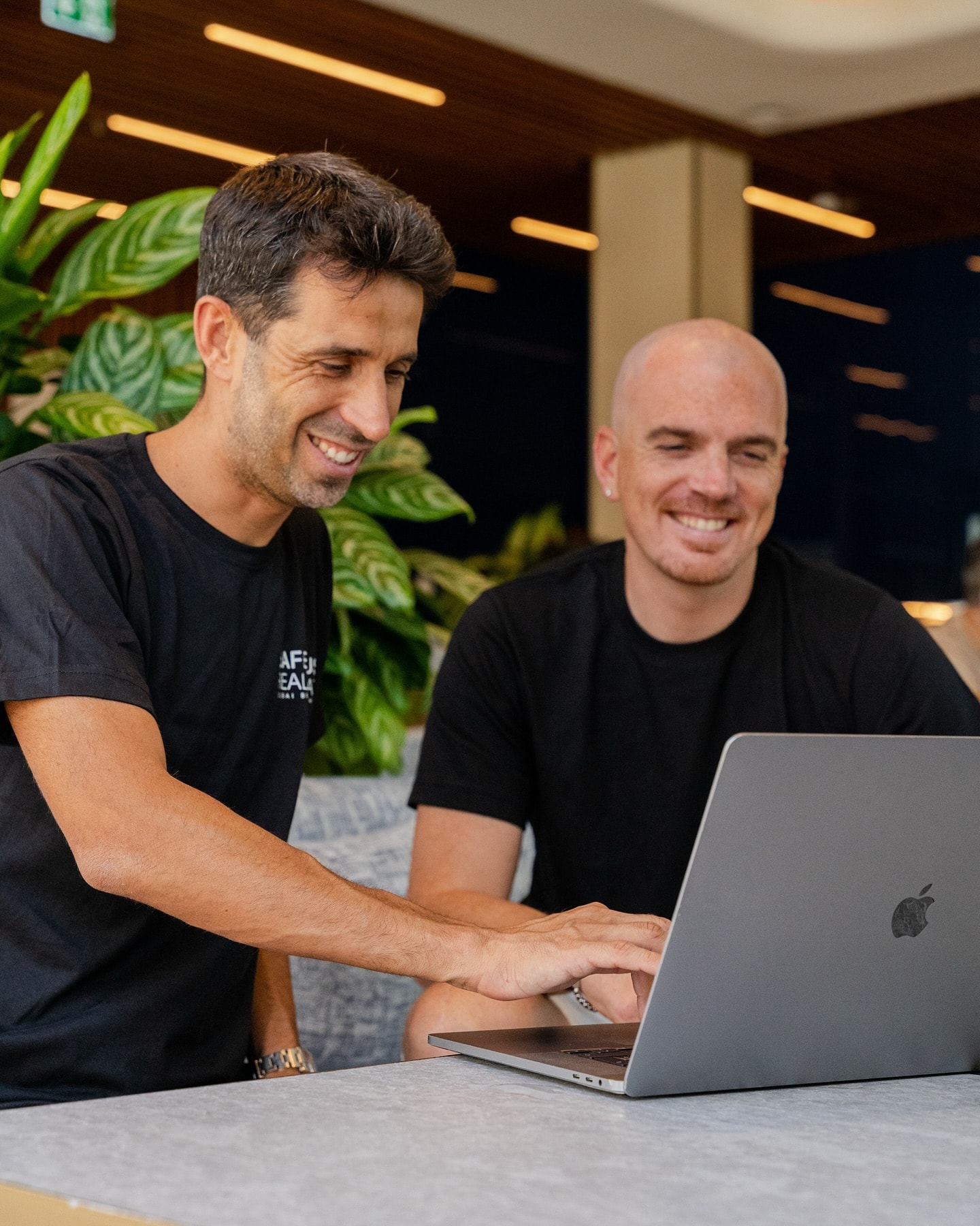 Alessandro Picchianti working with a colleague on a laptop