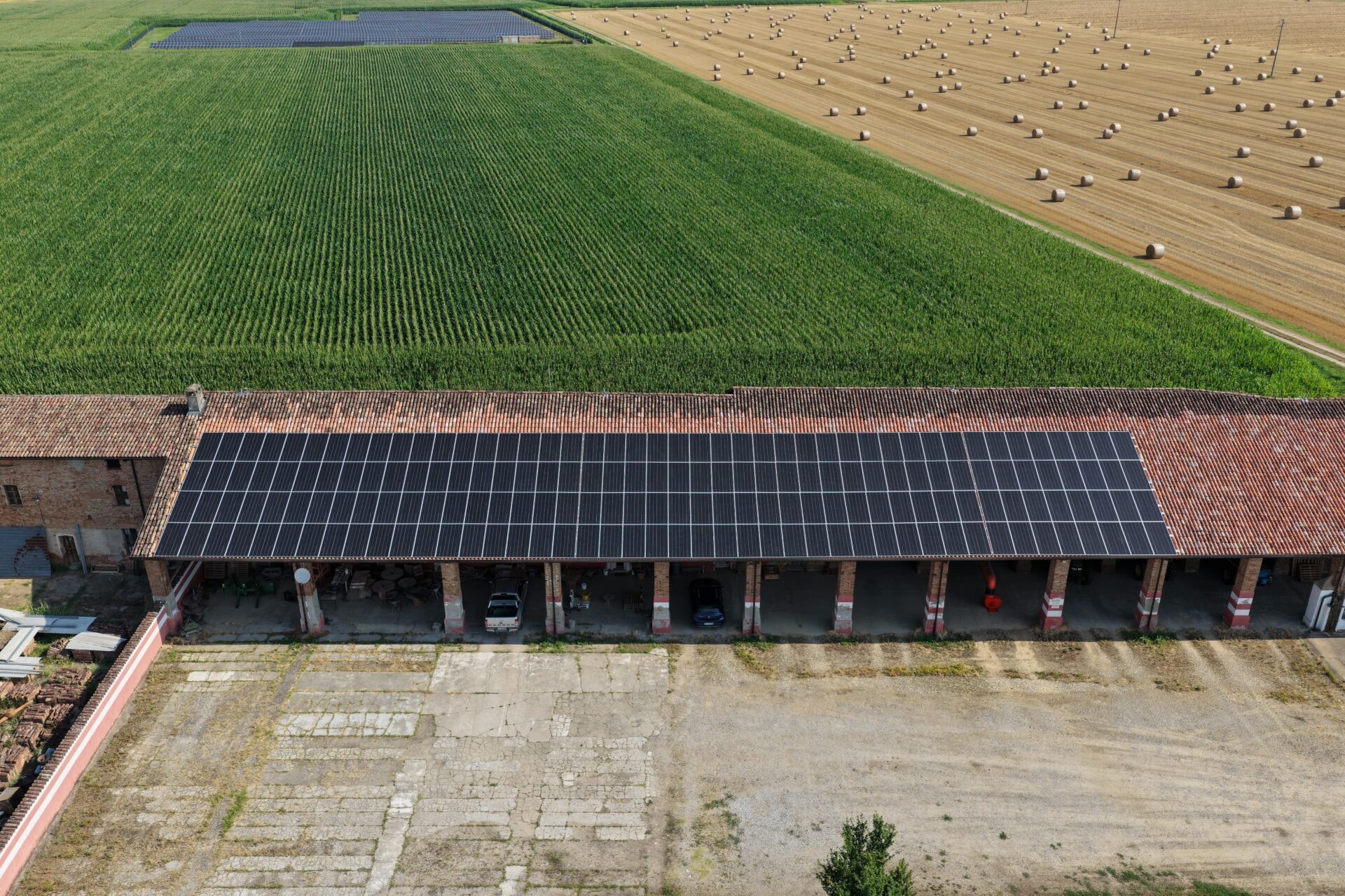 Aerial view of solar panels on a farm building roof, installed by Solar Bee