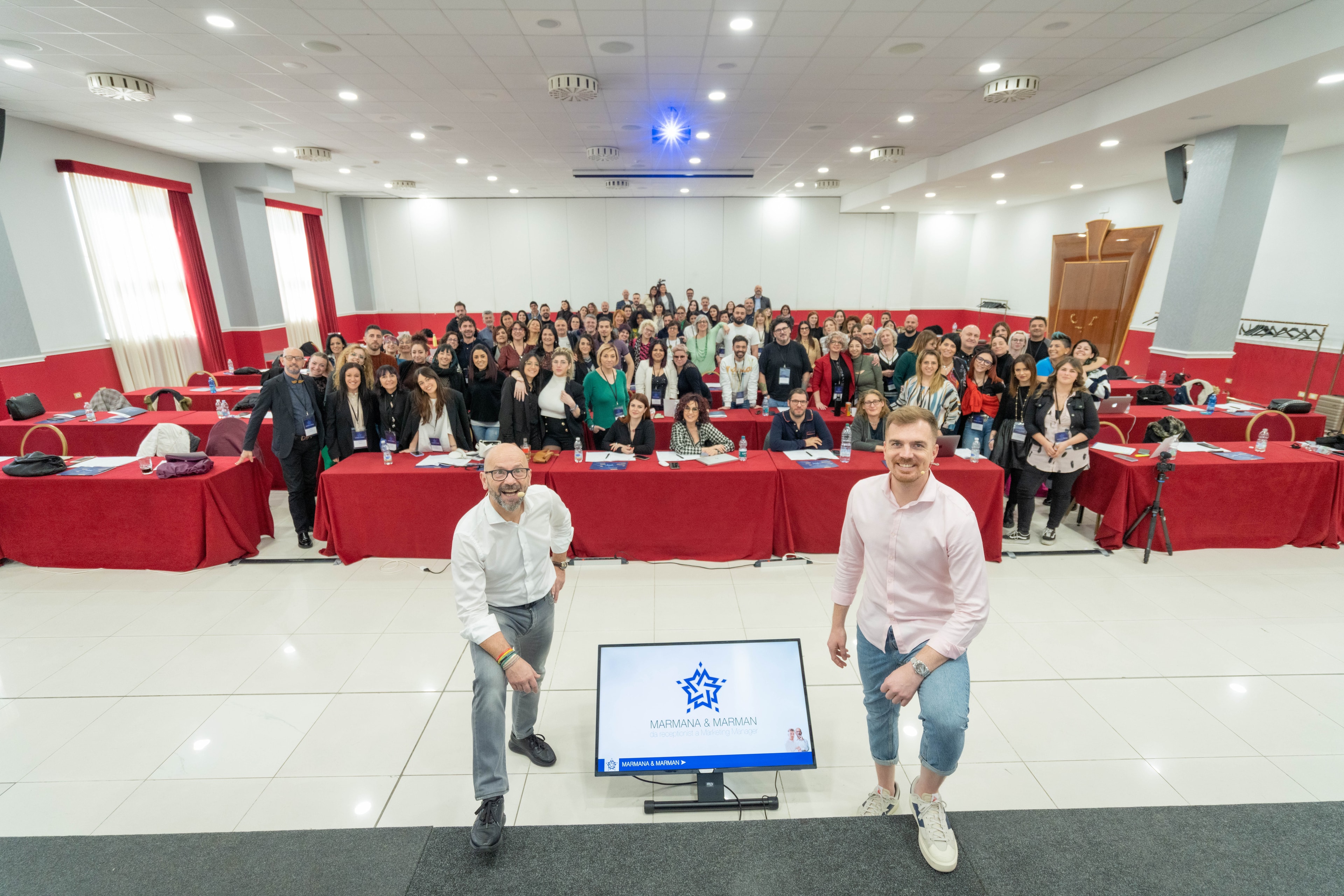 Alessandro Picchianti and his business partner in front of a full room of training attendees