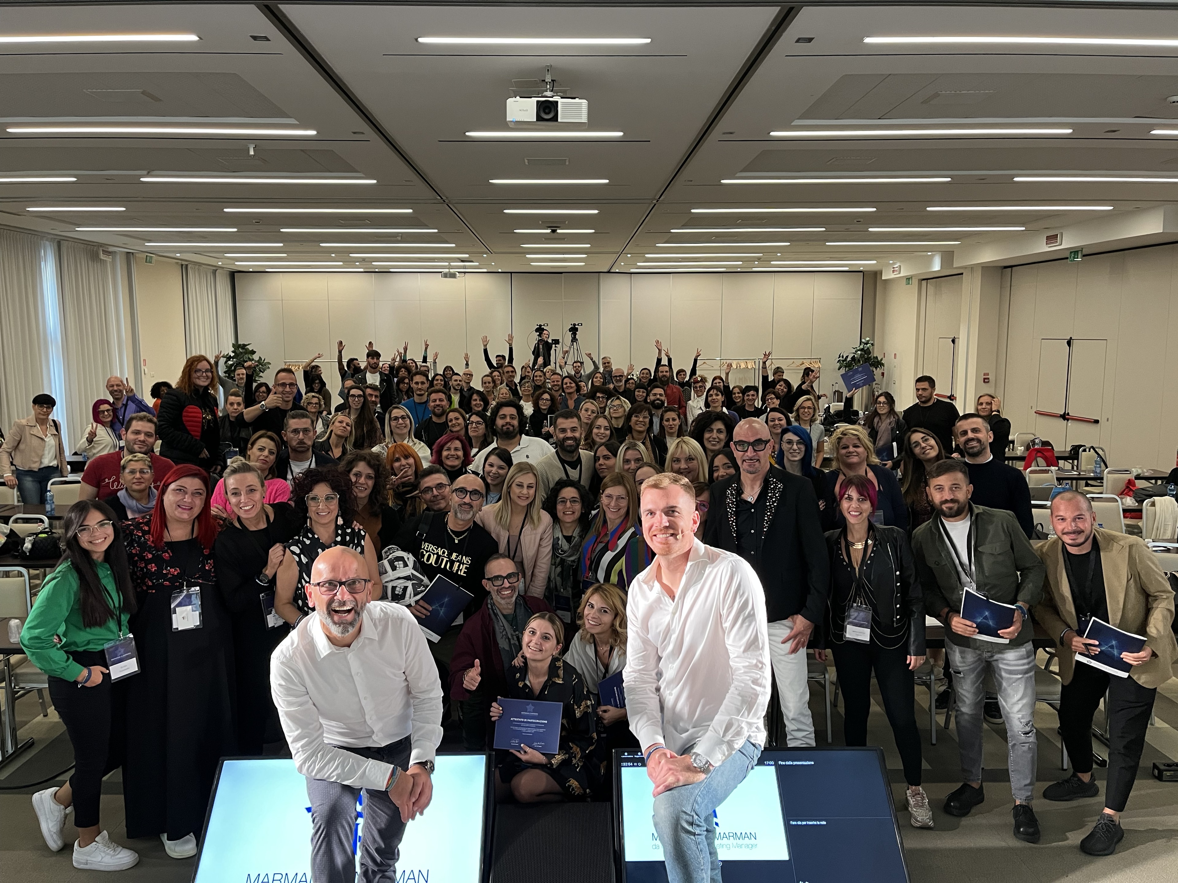 Alessandro Picchianti on stage with a cheering audience behind him