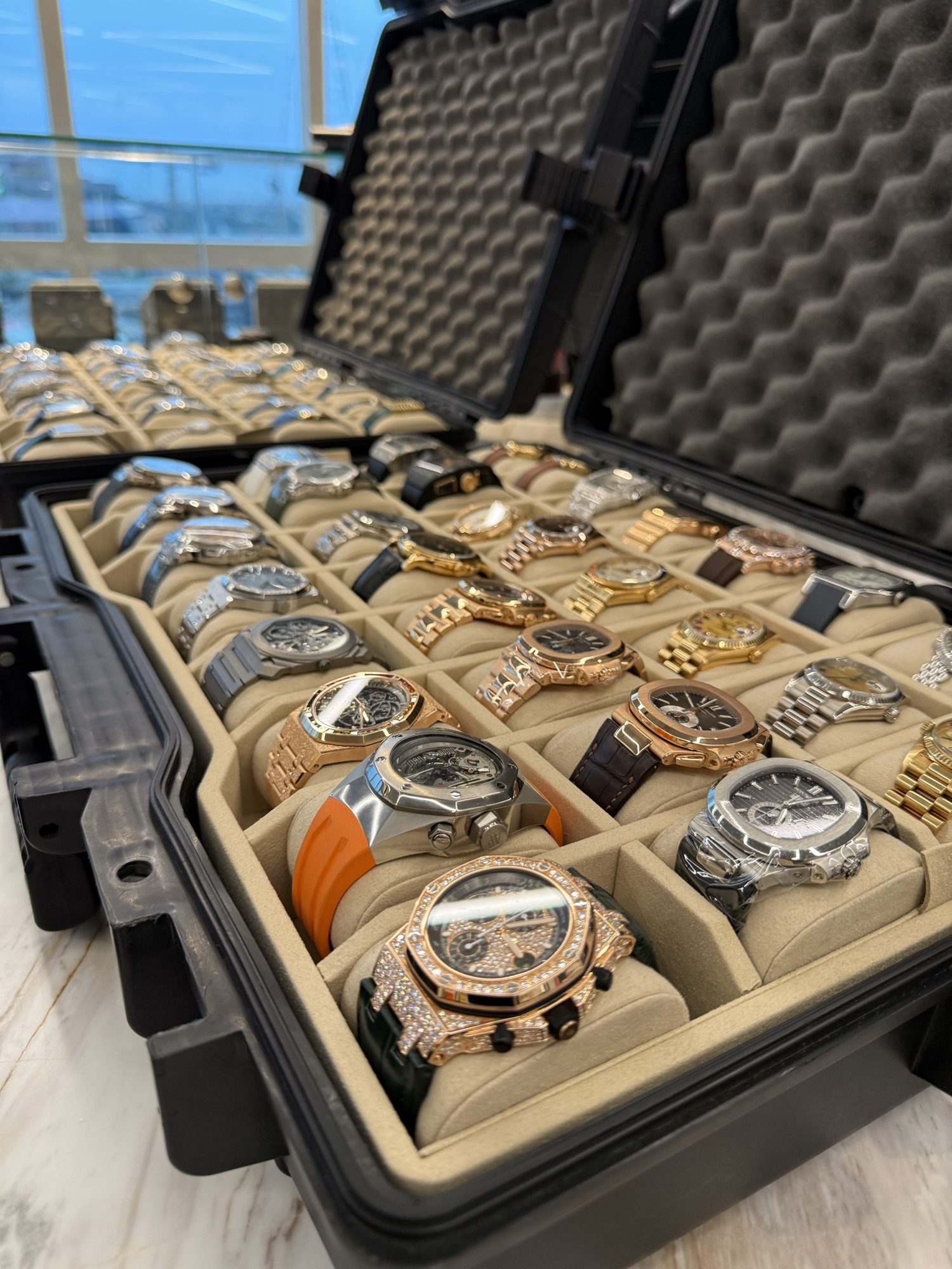 Luxury watches lined up in an open travel case